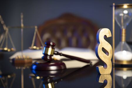 Law concept. Judgeâ€™s gavel, paragrahp sign and scale on dark background.