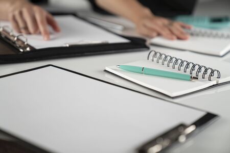 Business woman concept. Cropped image of businesswoman working in office, supplies on tabletop.の写真素材