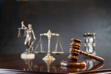 Law theme. Gavel of the judge, Themis statue and scale of justice on gray background.の写真素材