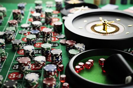 Casino concept. Gambling games.  Roulette, dice and chips on the roulette table with red and black numbers.の写真素材