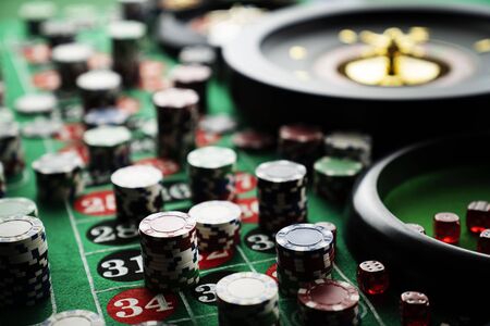Casino concept. Gambling games.  Roulette, dice and chips on the roulette table with red and black numbers.の写真素材