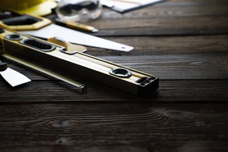 Tool kit of the contractor on the rustic wooden