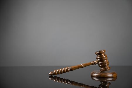 Gavel on gray background. Law, auction and business concept.