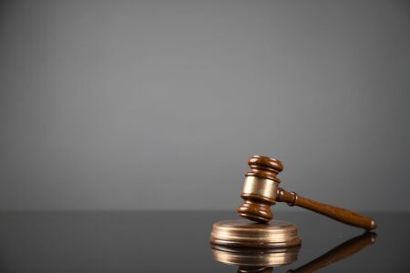 Gavel on gray background. Law, auction and business concept.