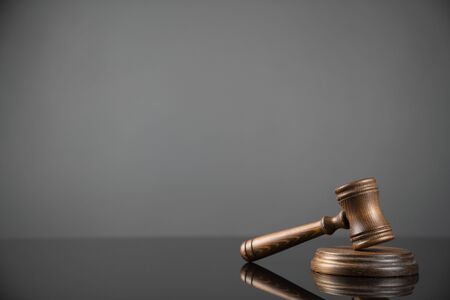 Gavel on gray background. Law, auction and business concept.