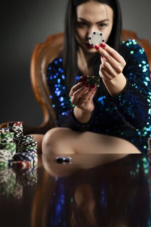 Casino. Portrait of pretty young female casino player.の写真素材