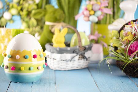 Easter theme. Easter decorations. Easter eggs in basket and cabbage leaf. Bouquet of spring flowers....