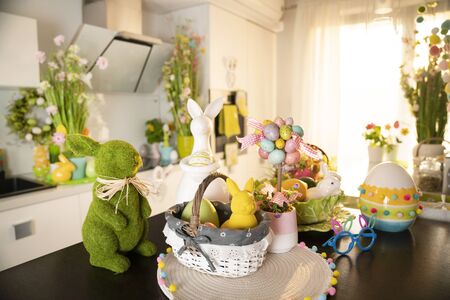 Easter theme. Easter decorations. Easter eggs in basket and easter bunny. Bouquet of spring flowers.