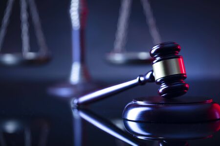 Law symbols composition. Gavel and scale on blue background.の写真素材