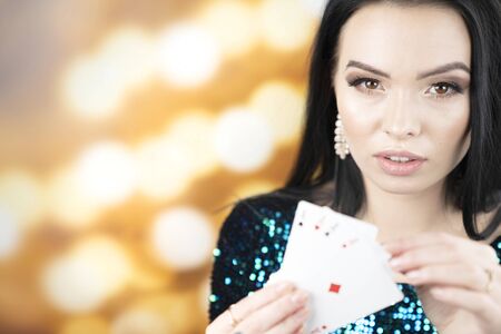 Female casino player. Winning combination of poker cards.