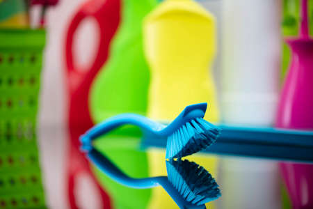 House and office cleaning theme. Colorful cleaning kit on glass table.の写真素材