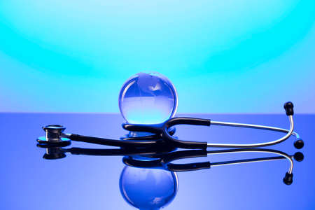 Healthcare concept. Stethoscope and medicines. Blue table and background.の写真素材