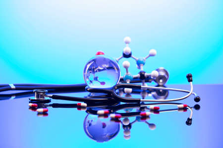 Healthcare concept. Stethoscope and medicines. Blue table and background.の写真素材