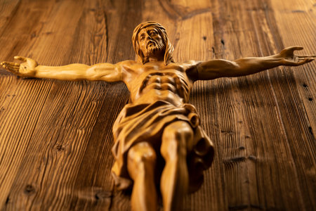 Religion theme - Jesus Christ. Cruciefied Jesus figure isolated on rustic  brown table.の写真素材