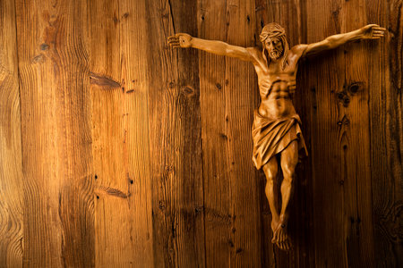 Religion theme - Jesus Christ. Cruciefied Jesus figure isolated on rustic  brown table.の写真素材