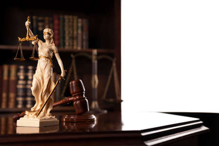 Law theme. Judge chamber. Judgeâs gavel, Themis sculpture and collection of legal books on the brown background.の写真素材
