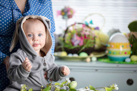 Easter time. Portrait of beautiful little baby boy with easter decorations.の写真素材