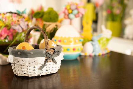 Easter decorations in the house. Easter bunny, easter eggs in basket and cabbage leaf. Bouquets of spring flowers.の写真素材
