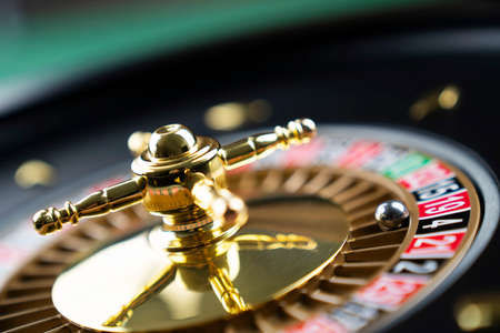Casino theme.  Roulette wheel on green table.の写真素材