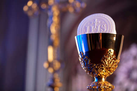 First Holy Communion. Catholic religion theme. Crucifix, the Croass and Golden chalice and wafer on...