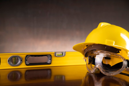 Labour law and builiding law concept.  Gavel and yellow crash helmet on the shining lawyer desk.の写真素材
