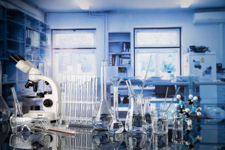Laboratory investigations concerning test and medicine against covid. Microscope, glass tubes and beakers in the laboratory.の写真素材