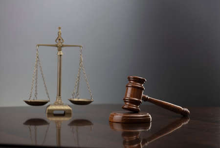 Law symbols composition. Law and justice concept.  Gavel and scale on gray background.