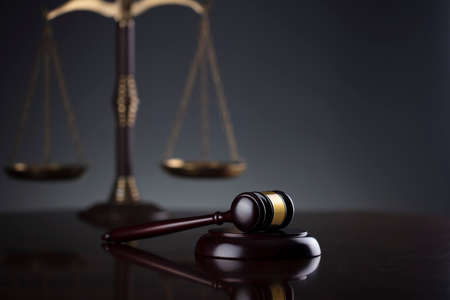 Law symbols composition. Law and justice concept.  Gavel and scale on gray background.
