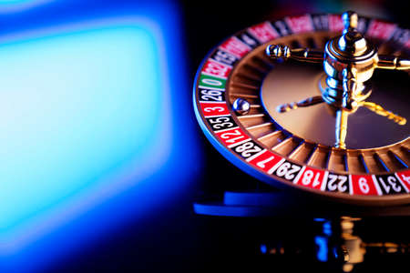 Casino theme.  Roulette wheel on  colorful bokeh background.の写真素材