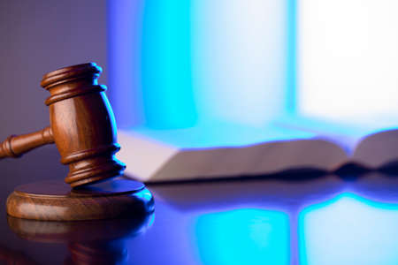 Law concept. Gavel, Themis sculpture and law code in lawyers office. Bluelight background.の写真素材