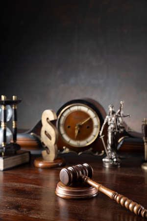 Law and justice concept. War crimes. Gavel, Themis sculpture, law code and scale in lawyers office. Gray background.の写真素材
