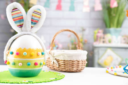 Easter time. Easter decorations on the white background. Easter bunny, easter eggs in basket....