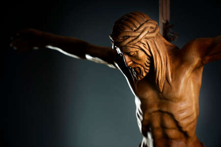 Religion theme - Jesus Christ. Cruciefied Jesus figure isolated on rustic dark background.の写真素材