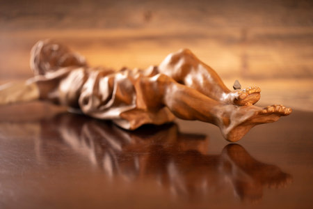 Religion theme - Jesus Christ. Cruciefied Jesus figure isolated on wooden brown background.の写真素材