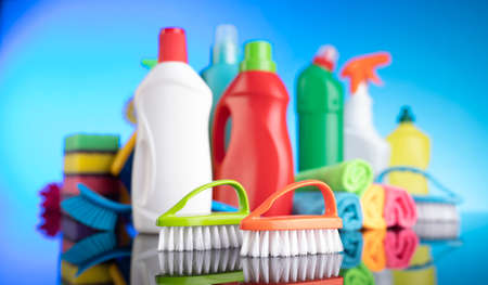Spring house cleaning. Colorful cleaning kit on blue background.の写真素材