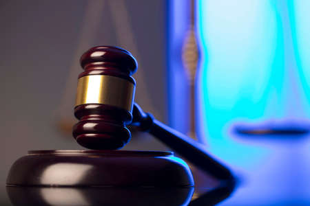 Lawyer office. Law symbols composition: judgeâ€™s gavel and scale. Blue light background.