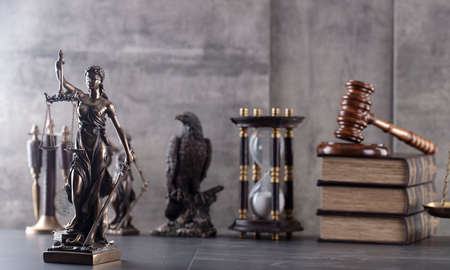 Law and justice concept. Justice symbol - Themis sculpture on gray background.