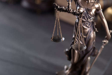 Law and justice concept. Justice symbol - Themis sculpture on gray background.