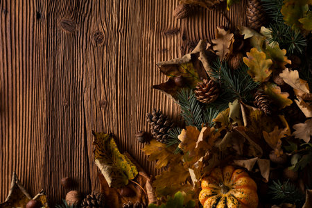 Autumn composition on a rustic wooden background. Decorative pumpkins, various leaves, 
pine cones, nuts. Orange, yellow, red  and brown aesthetics.の写真素材