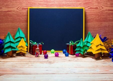Blank blackboard for your text on wooden background with Christmas tree, Christmas gift box decoration image for Christmas holiday concept.の写真素材
