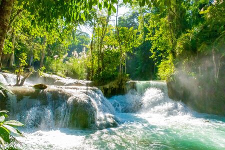 The waterfall Huay Mae Kamin is beautiful In tropical In Kanchanaburi Thailand. decoration image containâ certainâ grainâ noise andâ softâ focus.の写真素材