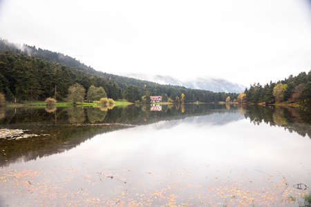 Autumn wooden Lake house inside forest in Bolu Golcuk National Park, Turkey wallpaper