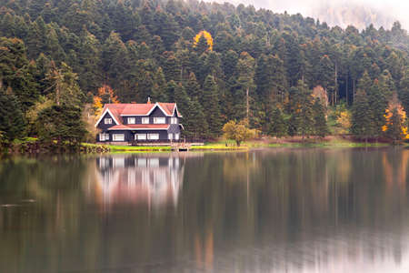 Autumn wooden Lake house inside forest in Bolu Golcuk National Park, Turkey wallpaperの写真素材
