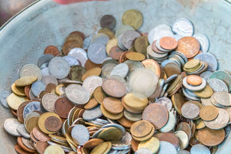 Old antique coins on display in antique shopの写真素材