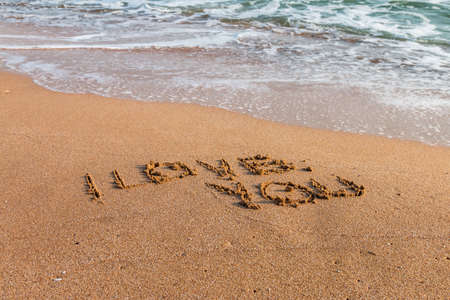 Romantic love lettering and heart sign on the beach beachの写真素材