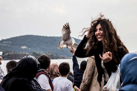 On the ferry to Kadikoy, children are feeding seagulls October1, 2020, ISTANBUL, TURKEYのeditorial素材