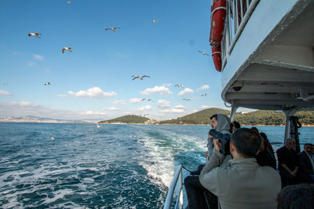 On the ferry to Kadikoy, children are feeding seagulls October1, 2020, ISTANBUL, TURKEYのeditorial素材
