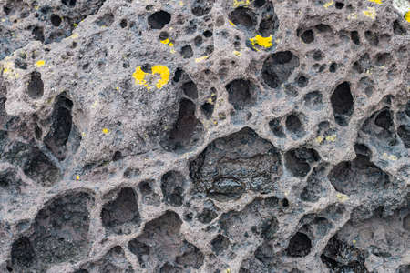 Meteor-like rocks by the seaの写真素材