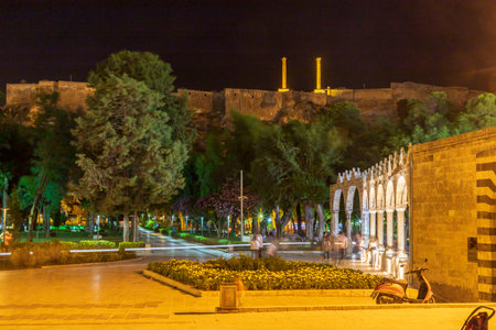 Night view of rizvaniye mosque in the front and SanlÄ±urfa castle in the backのeditorial素材
