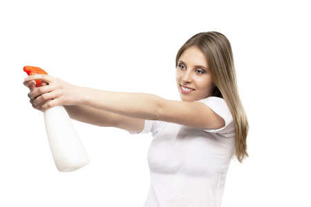 beautiful girl with spray detergent in the handsの写真素材
